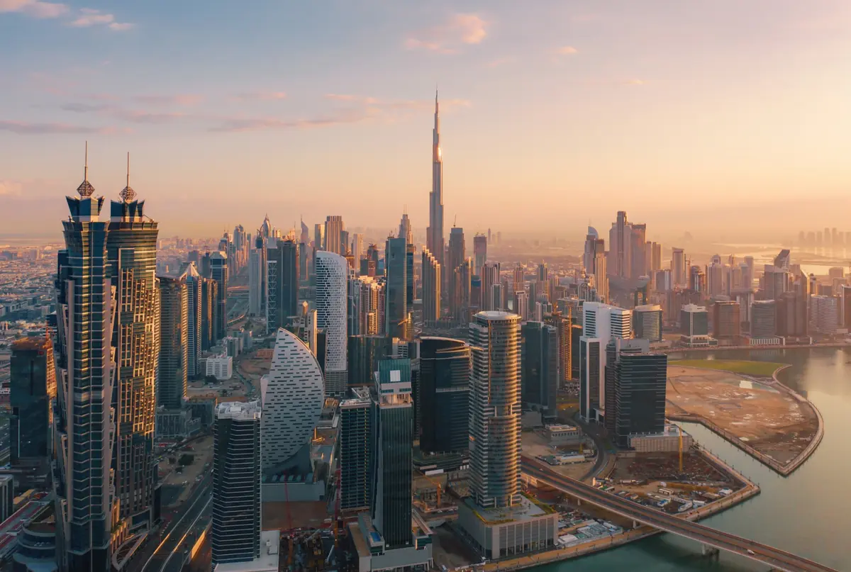 Dubai skyline at sunrise, with the Burj Khalifa above Business Bay
