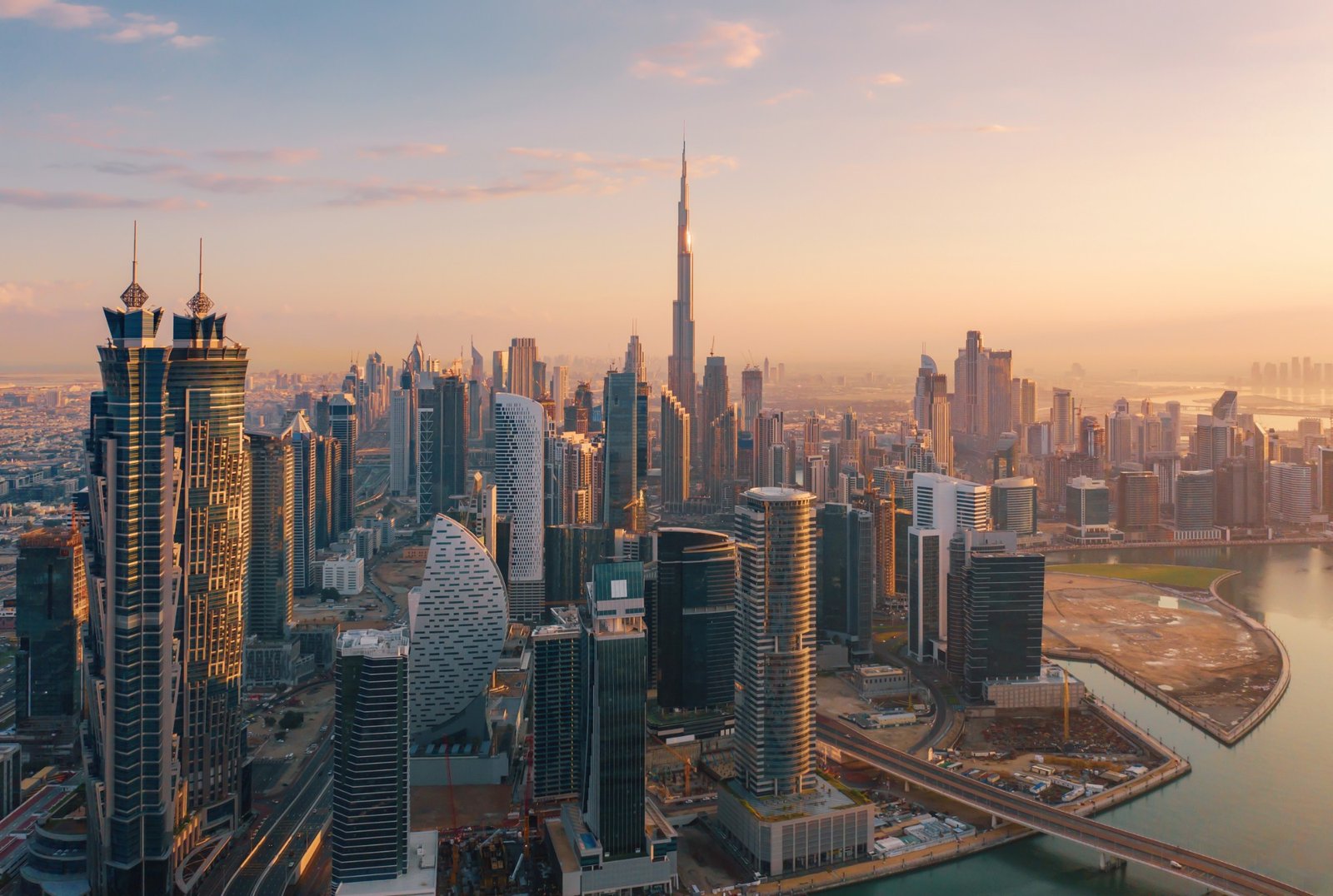 Dubai skyline at sunrise, with the Burj Khalifa above Business Bay