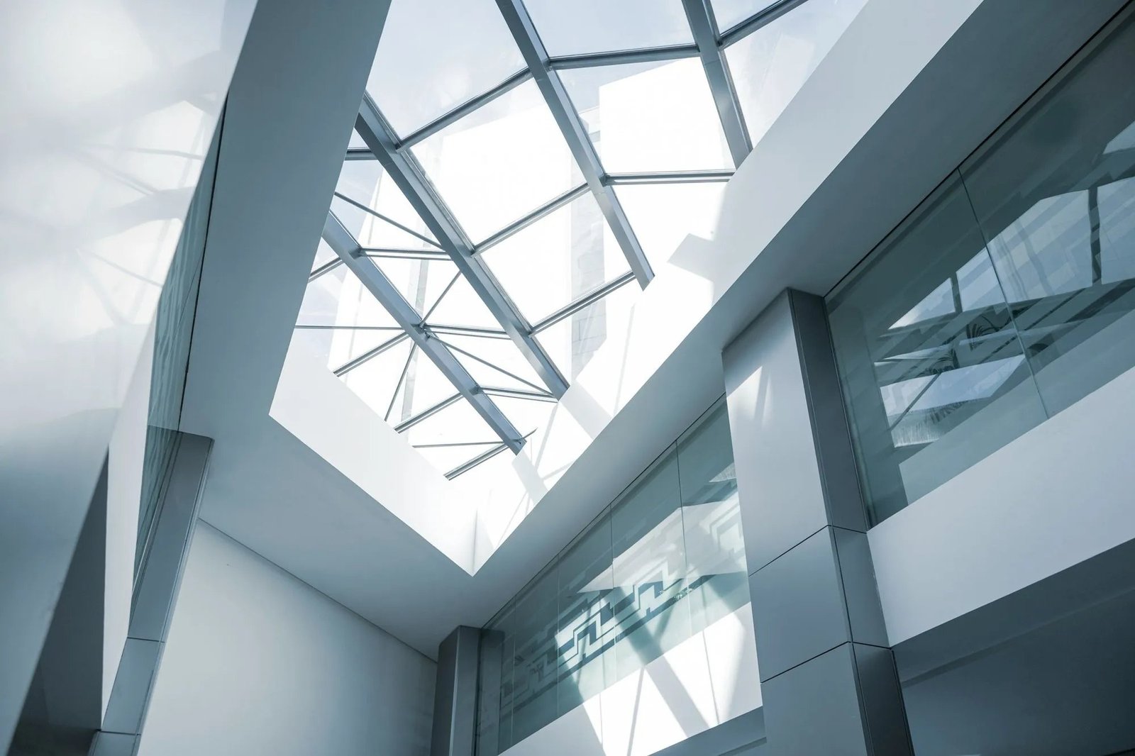 Glass roof and white galleries of a modern atrium